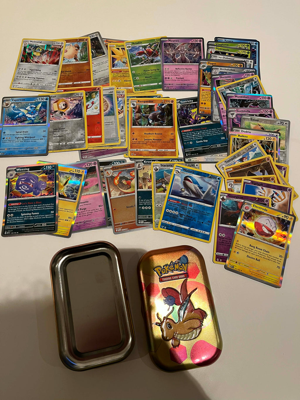 50 random Pokemon holos transported in a pokemon tin